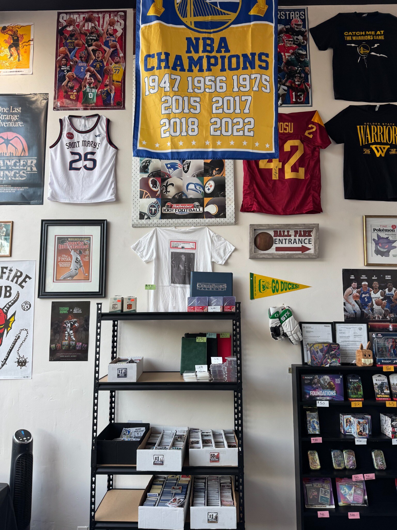 Memorabilia wall with jerseys and the NBA Champions banner
